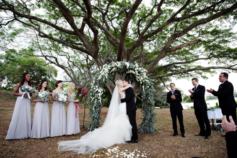 Bride and groom first kiss Francois Vedemme gown