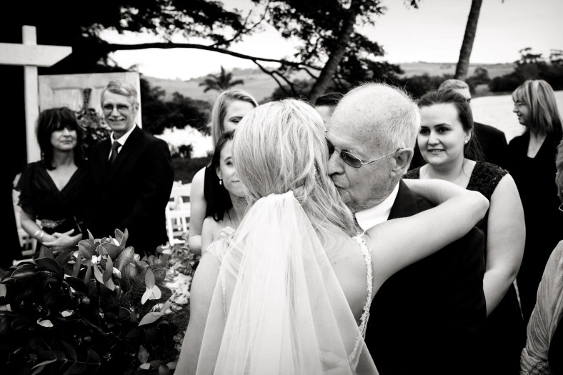 Grandfather kisses bride