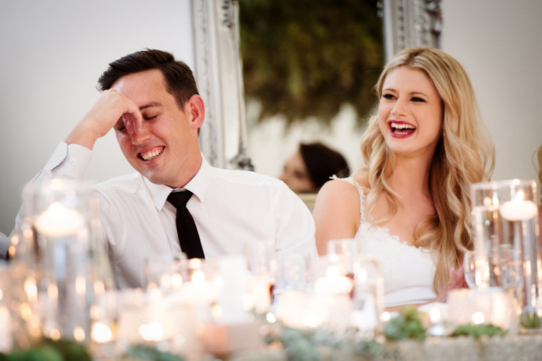 Bride and Groom laughing at speeches