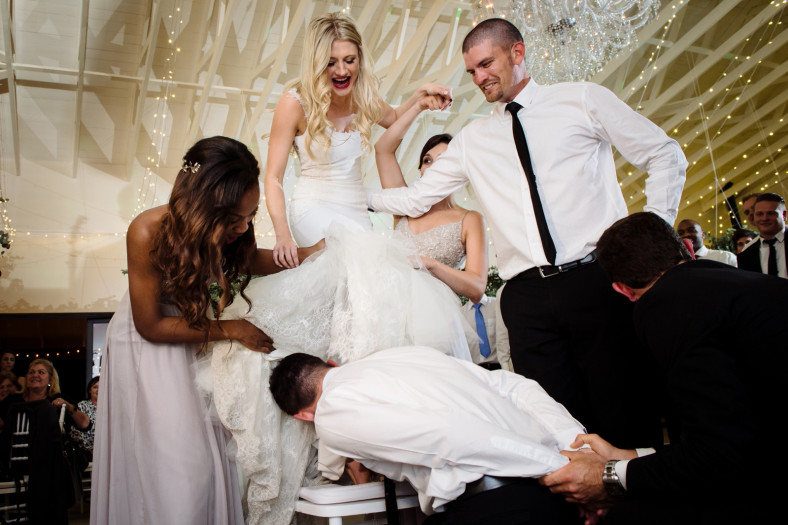 Groom fetching garter