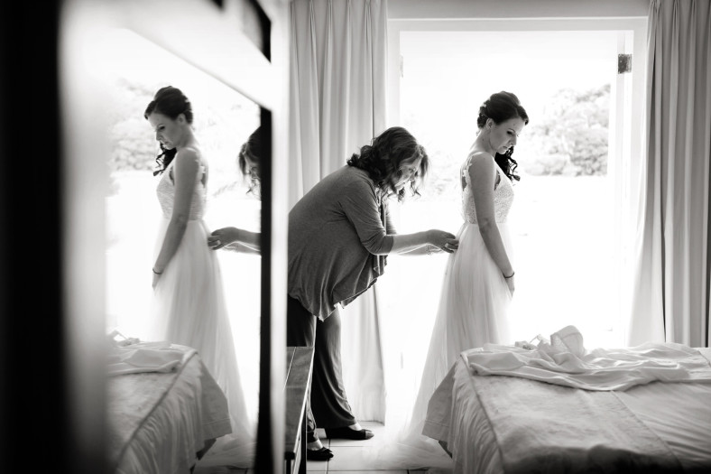 Mom dressing bride