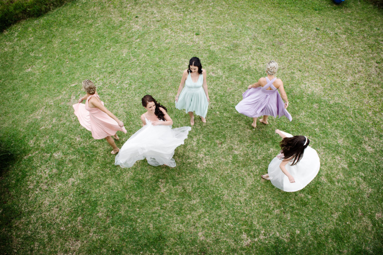 twirling bride and bridesmaids