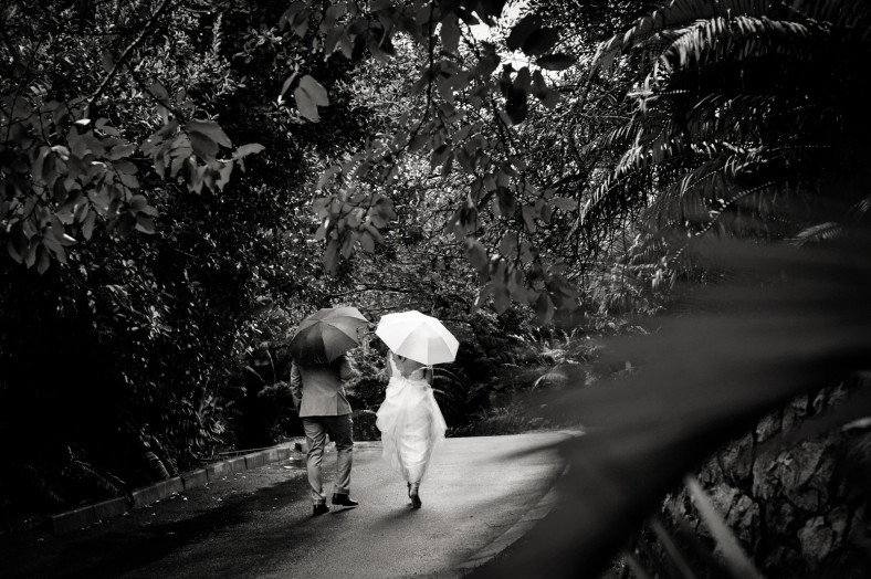 rainy wedding bride and groom walking