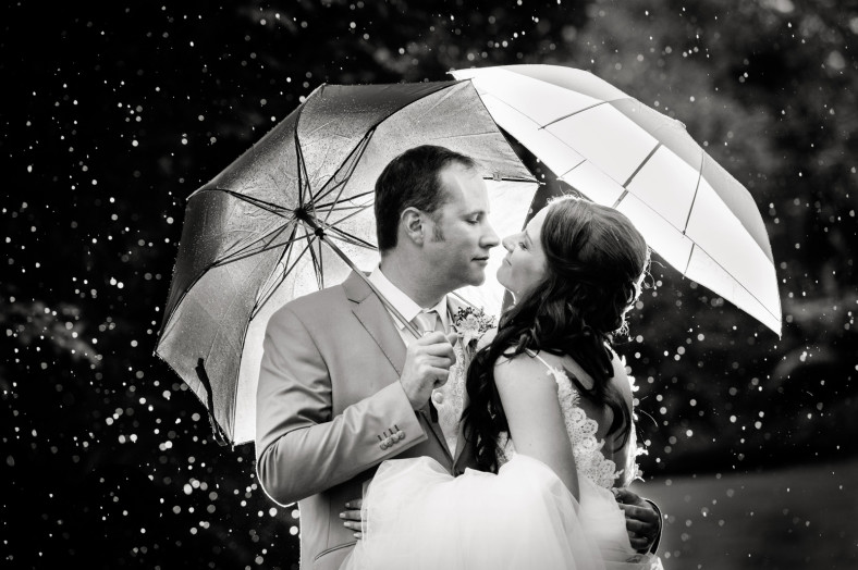 rainy wedding bride and groom with umbrellas