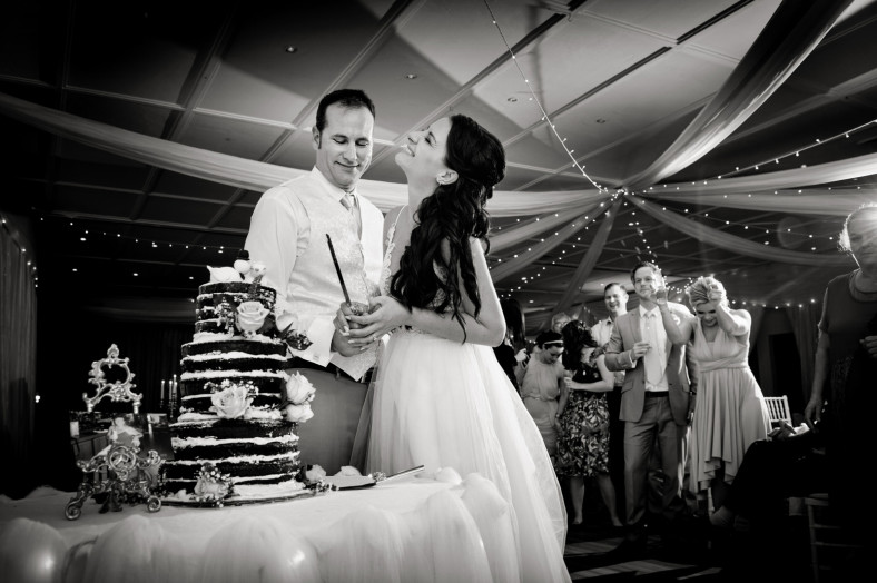 bride and groom cutting cake