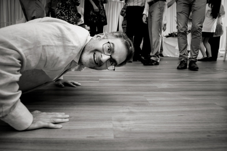 man peeking into camera on floor
