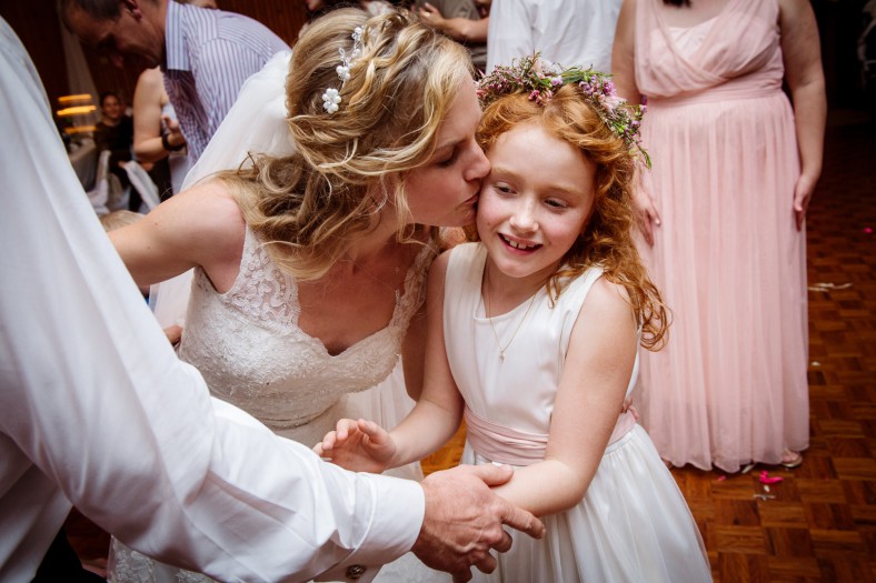 bride kissing daughter