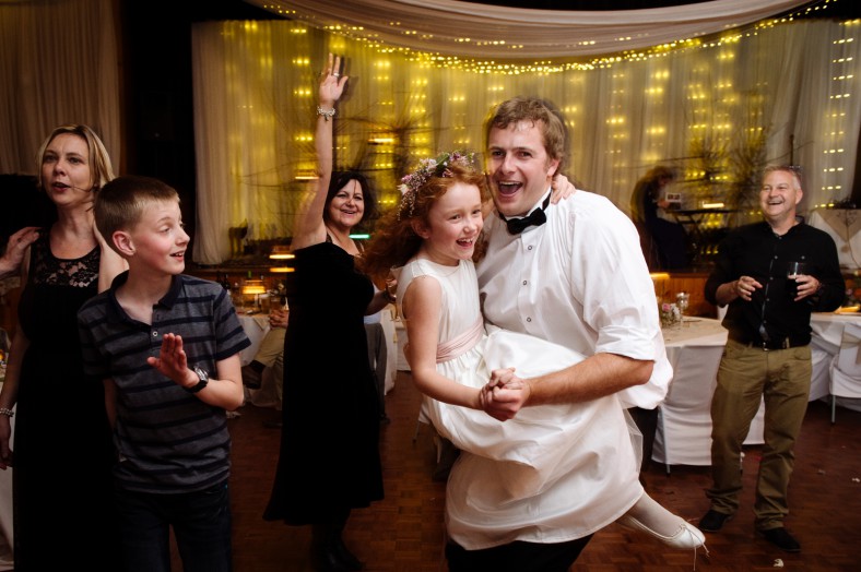 brother and flowergirl dancing