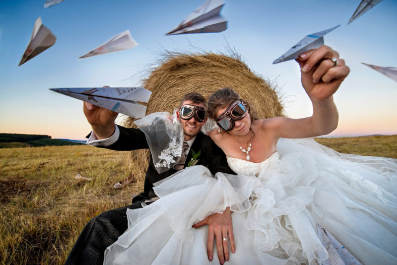 Bride and Groom with goggles and paper aeroplanes