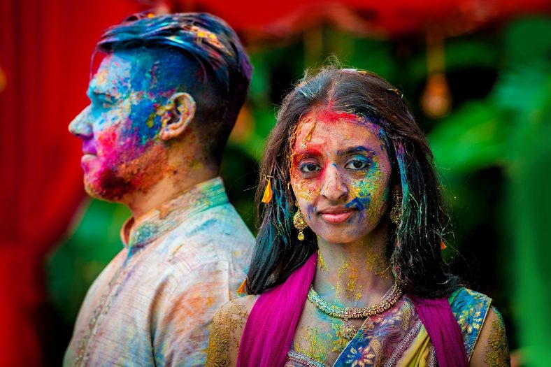 Creative Portrait photography of Hindu couple at Wedding Holi Fight.