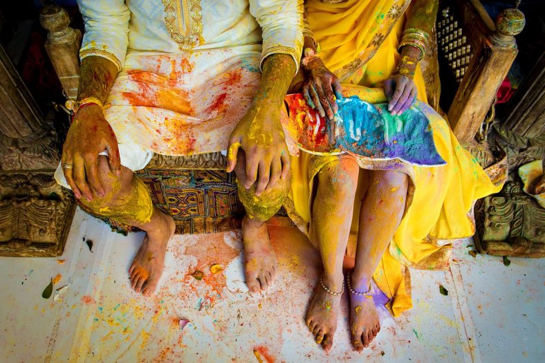 Holi colour fight at traditional hindu wedding function.