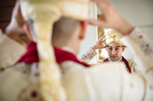 Indian man putting on wedding turban