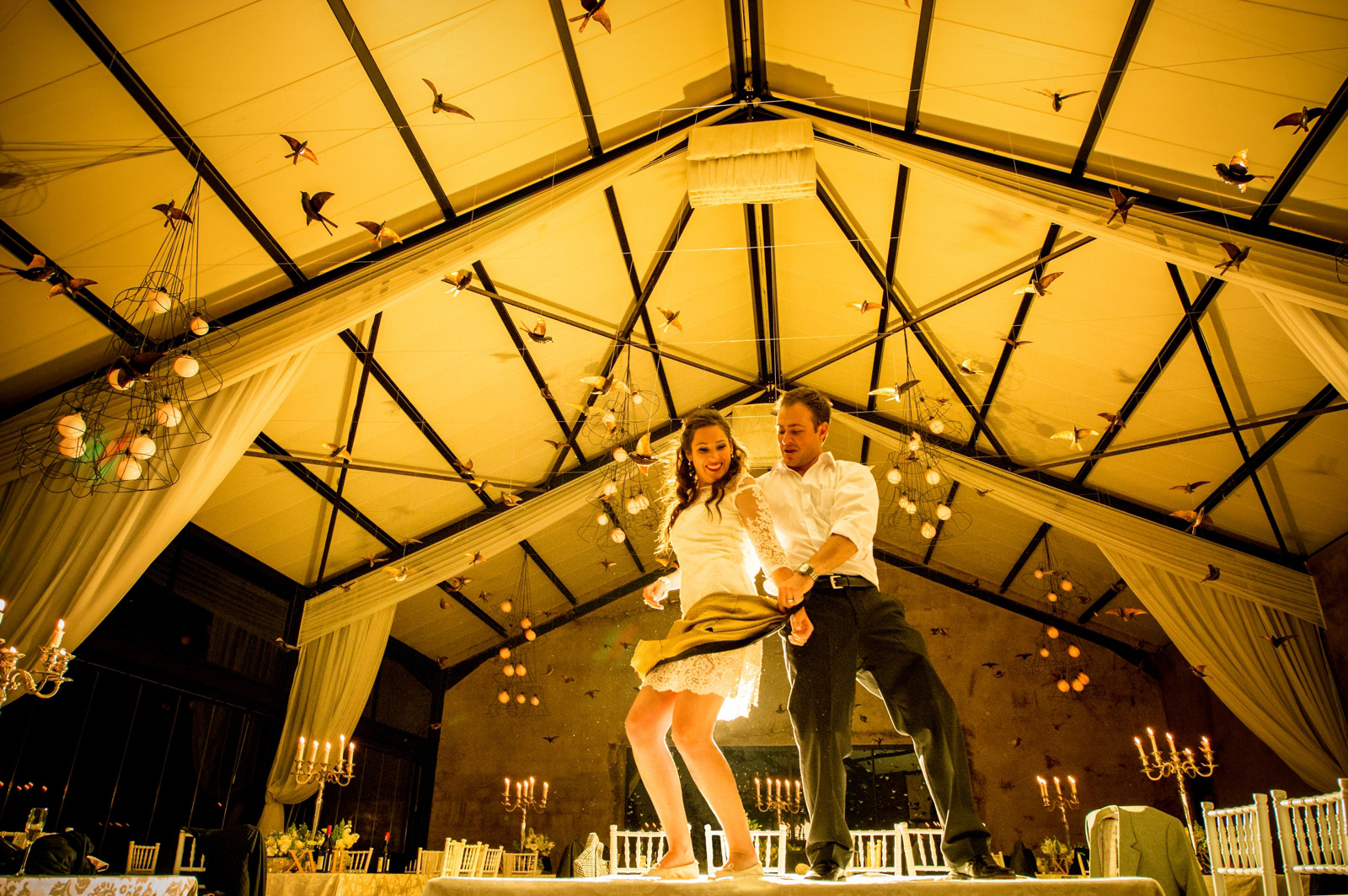 bride and groom dance on tables
