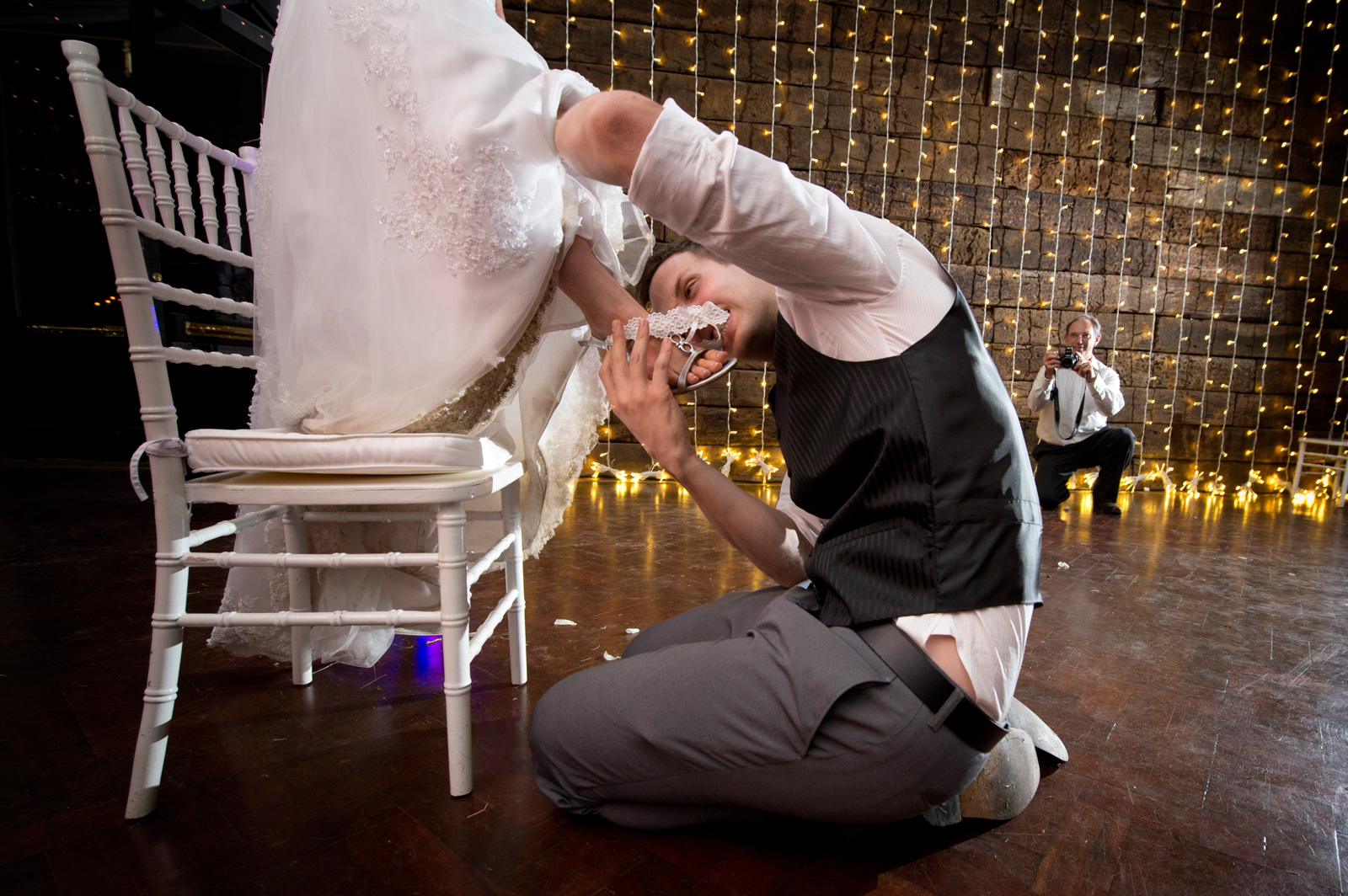 groom biting garter