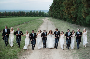 Bridal party running in field