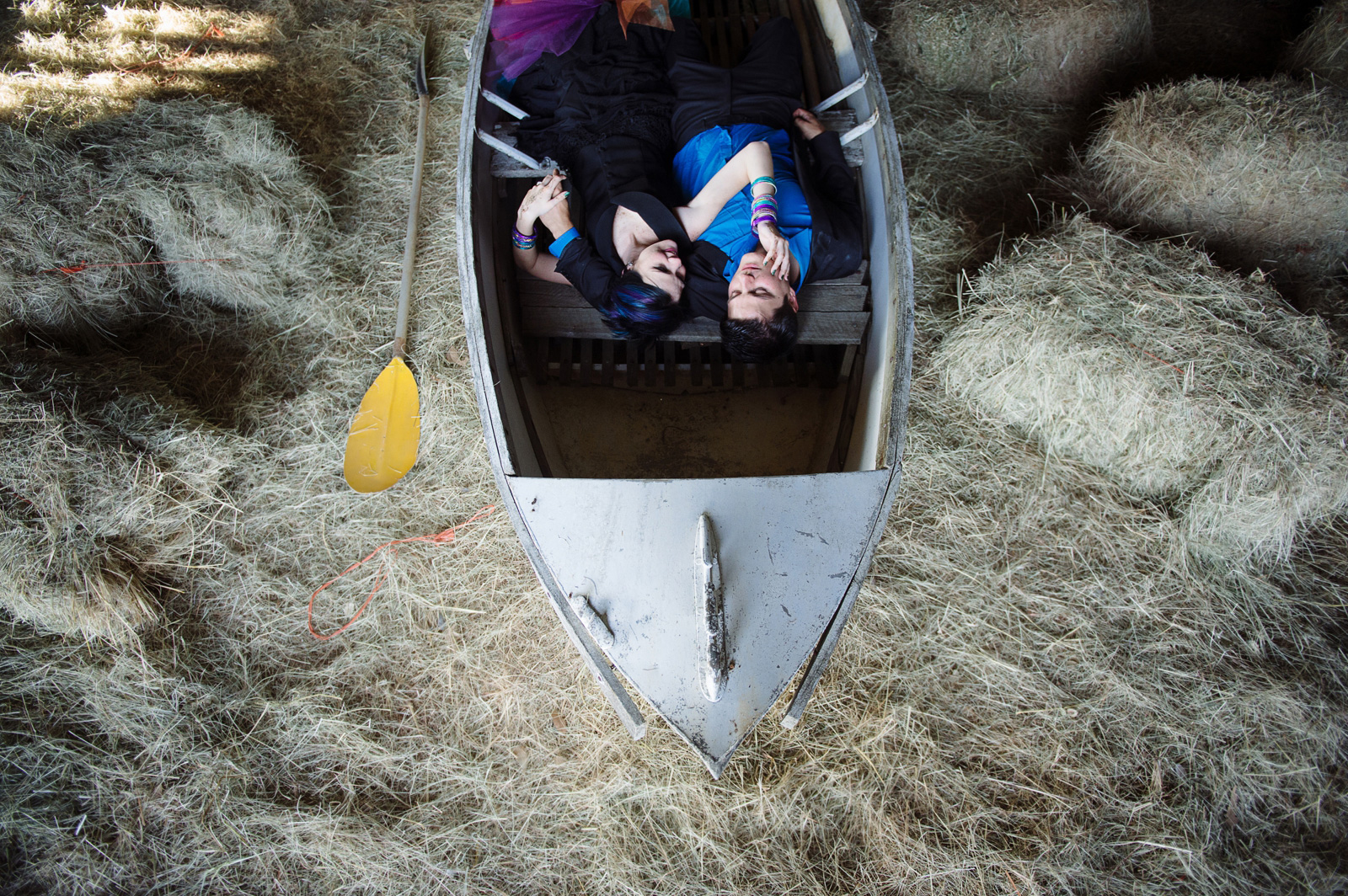 bride and groom in a boat in a barn